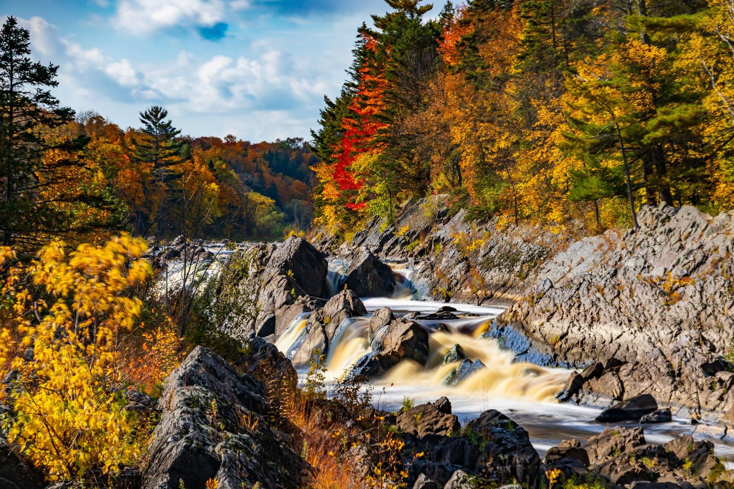 Long exposure fall waterfall landscape photography showing cascading water over mossy rocks in forests of Jay Cook, calming nature wall art.