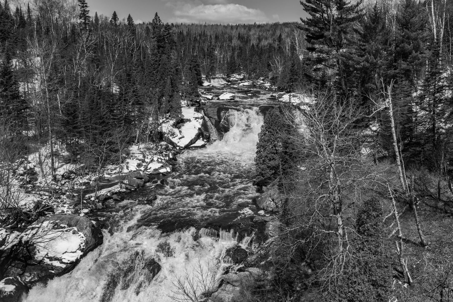 Long exposure, black and white waterfall landscape photography showing cascading water in forests of Northern MN, calming nature wall art.