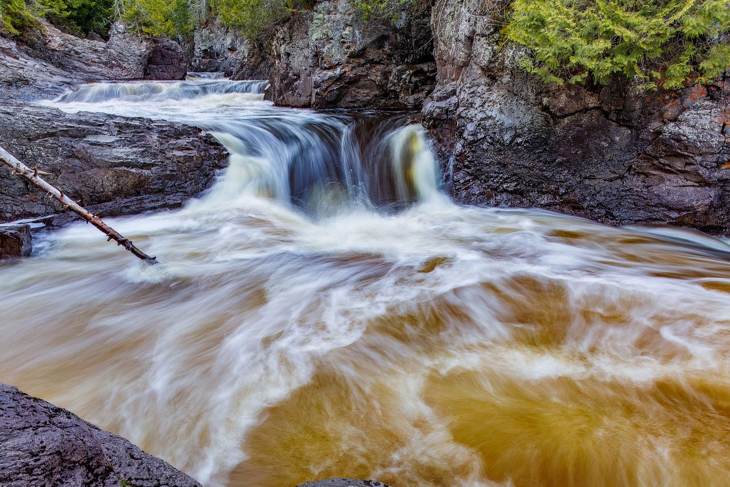Long exposure waterfall landscape photography showing cascading water over rocks in Cascade Park, North Shore MN, calming nature wall art.