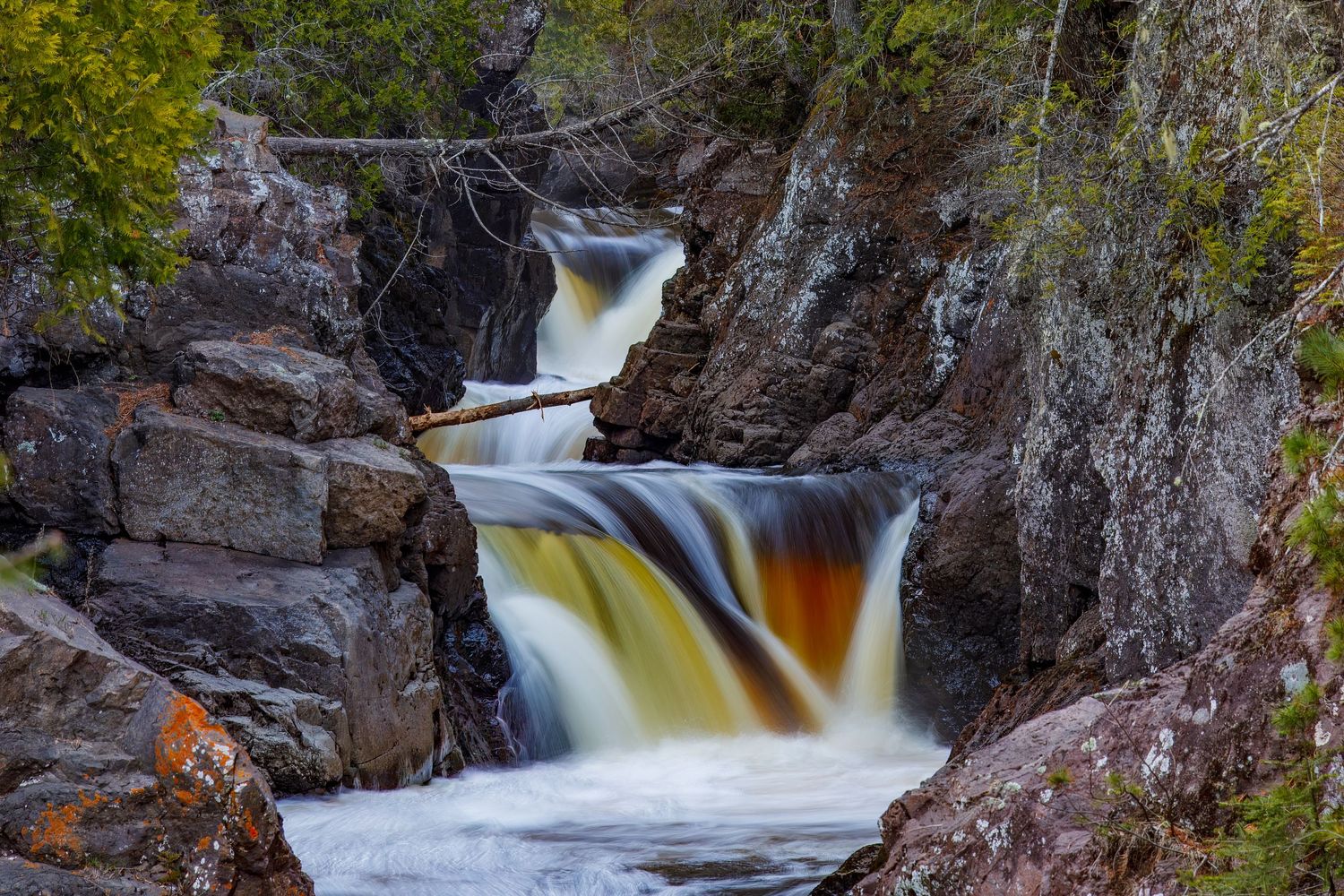 Long exposure waterfall landscape photography showing cascading water over rocks in Cascade Park, North Shore MN, calming nature wall art.