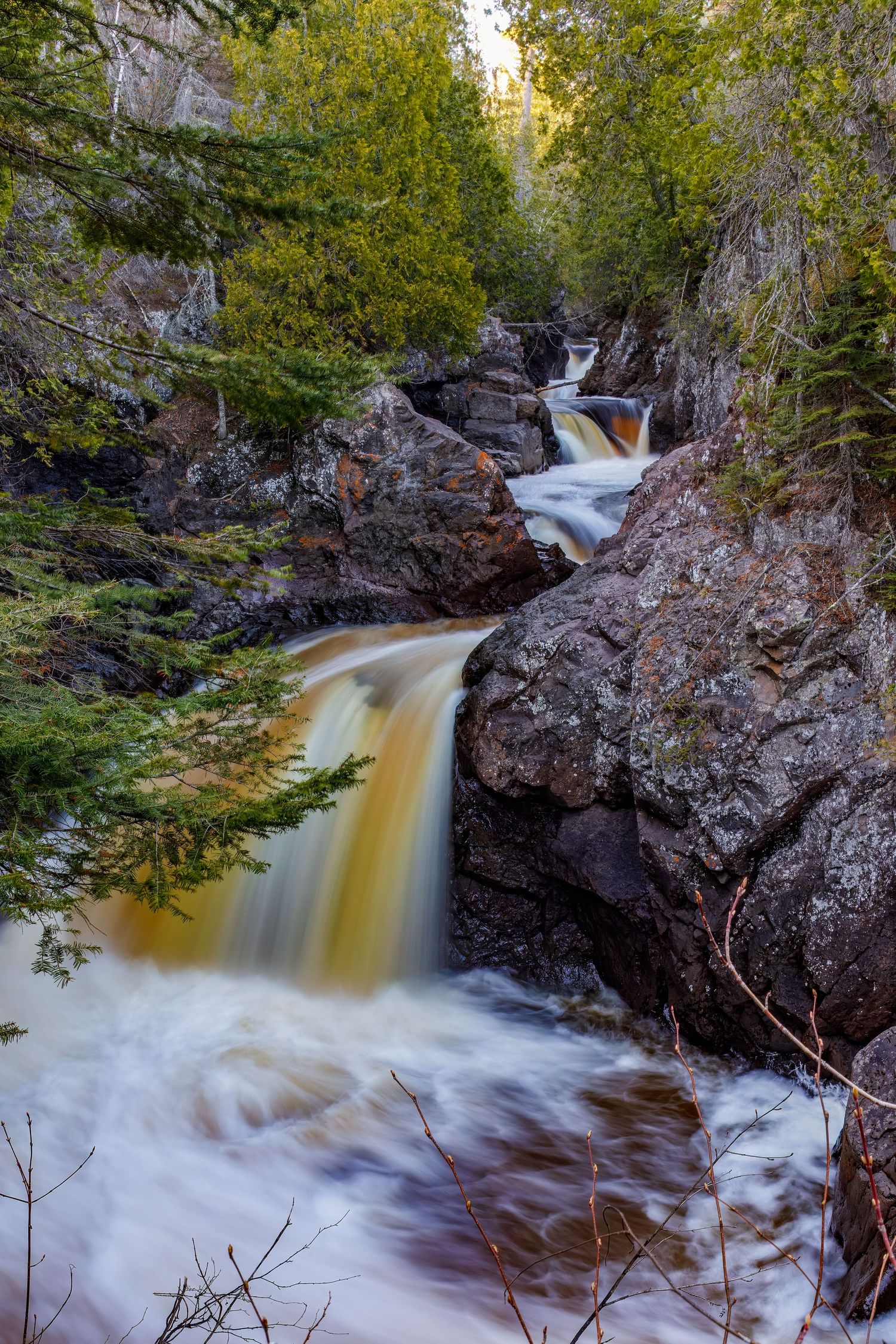 Long exposure waterfall landscape photography showing cascading water over rocks in Cascade Park, North Shore MN, calming nature wall art.
