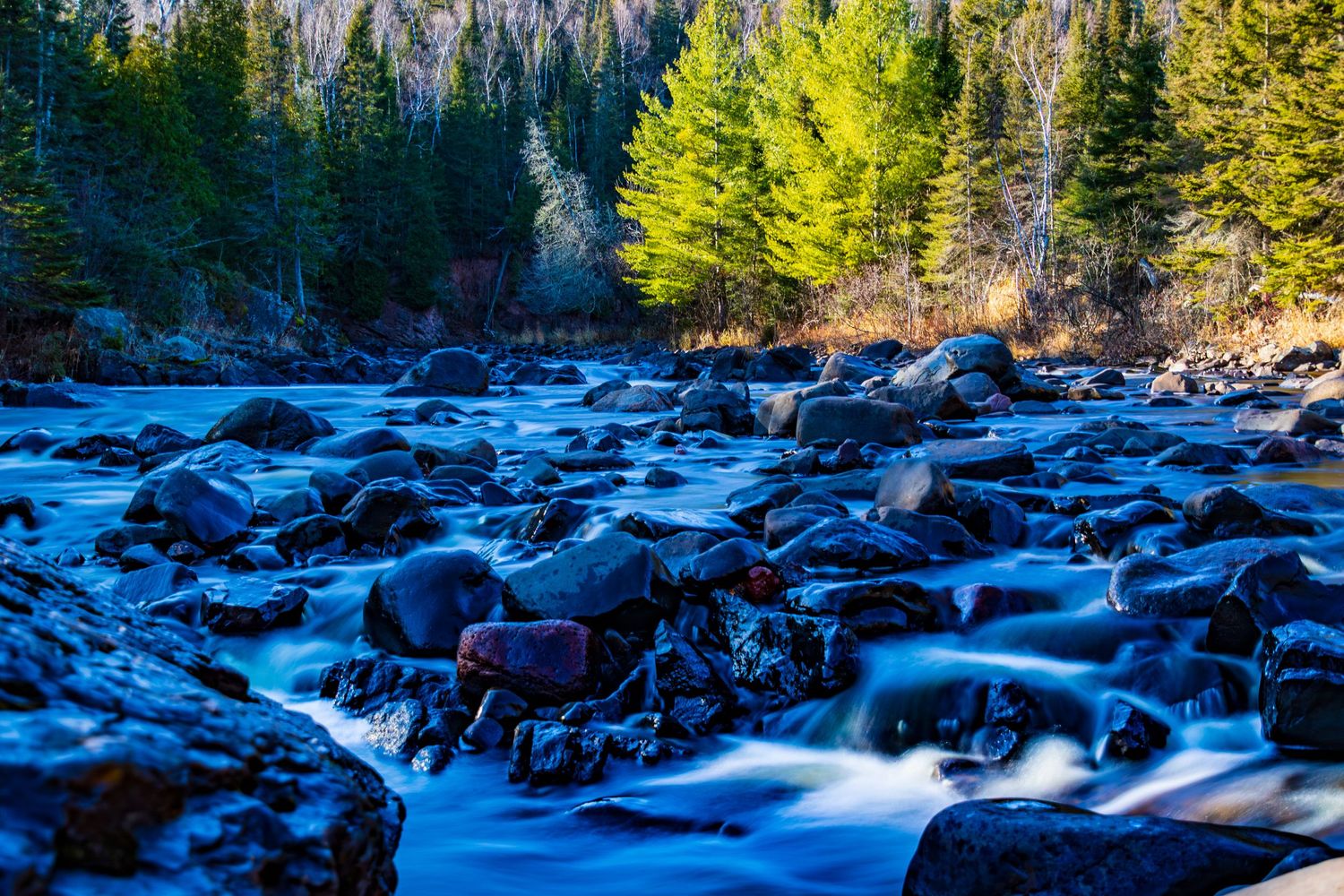 Long exposure fall waterfall landscape photography showing cascading water over mossy rocks on North Shore of MN , calming nature wall art.