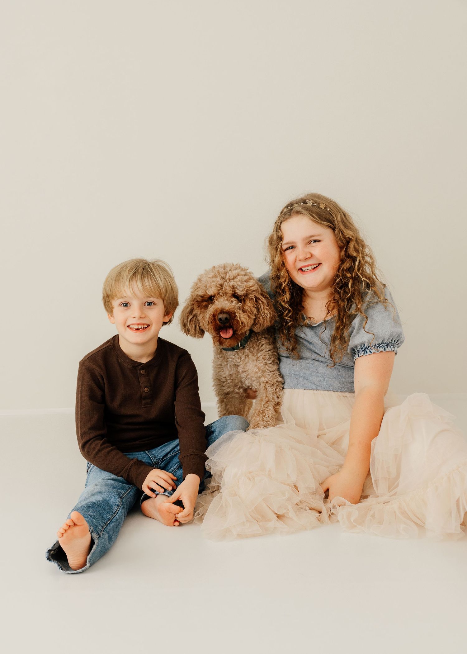 Three heartwarming photos of children and a fluffy brown dog posing together on a light-colored backdrop.