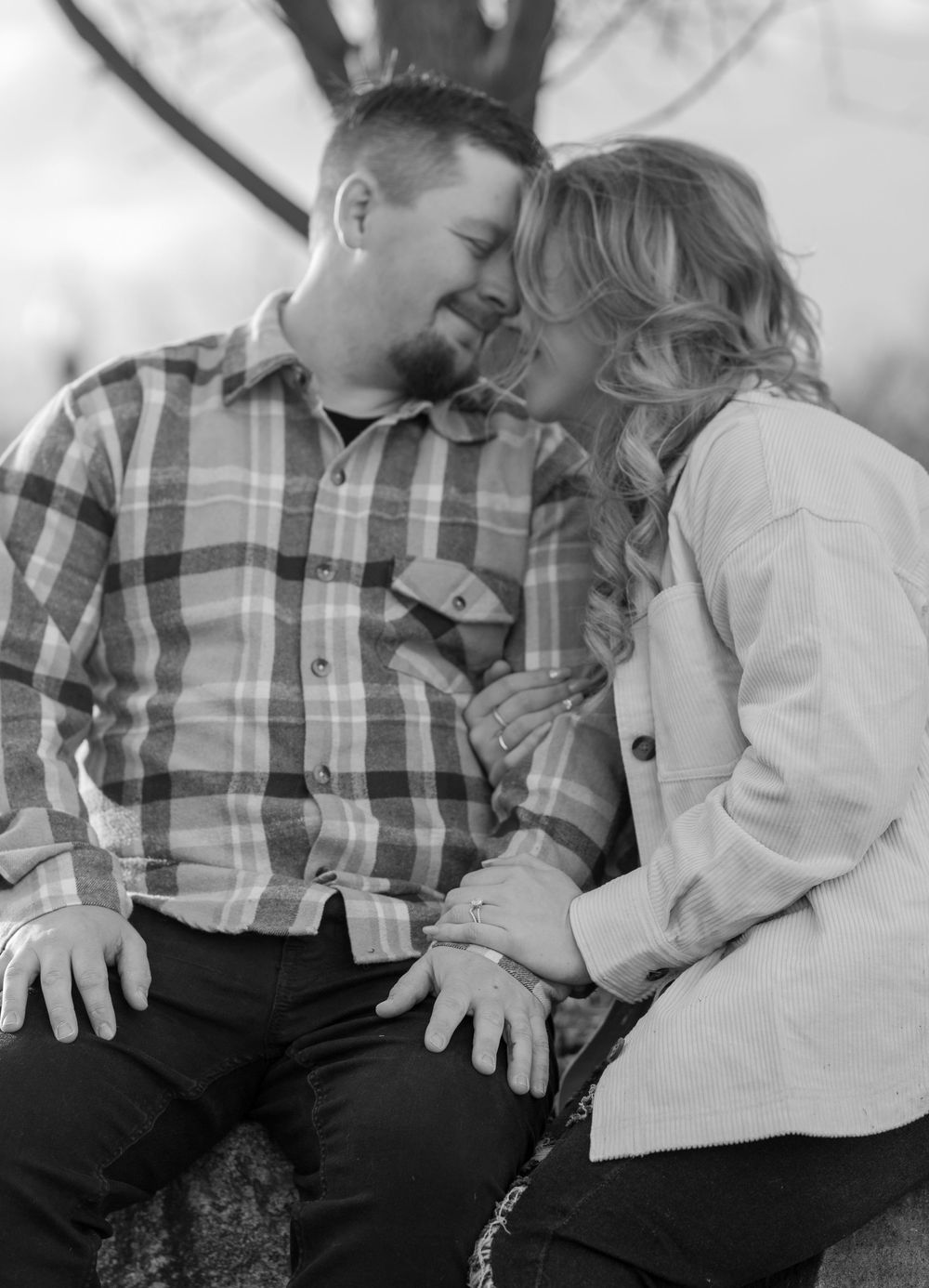A black and white photo series shows a couple in plaid and white shirts sharing intimate moments on a couch.