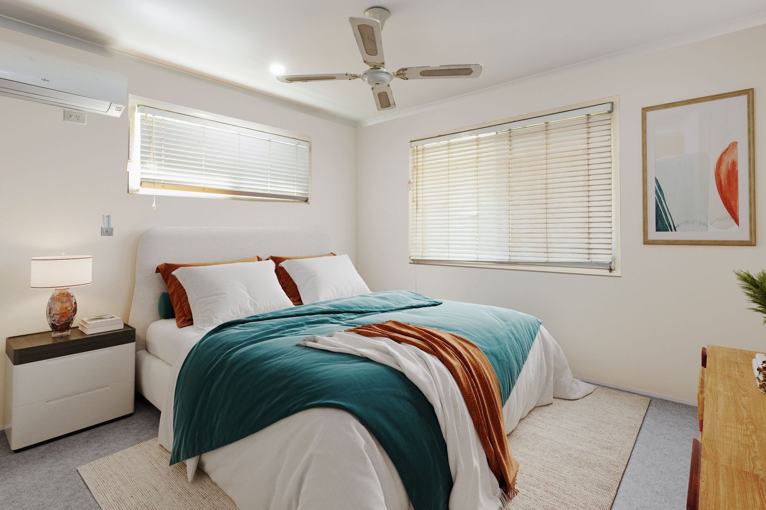 Modern bedroom with teal bedspread, ceiling fan, split system AC, white furniture, and venetian blinds.