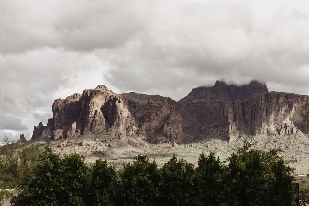 Panoramic view of rugged desert mountains with dramatic cloudy skies over the Superstition Mountains in Arizona.