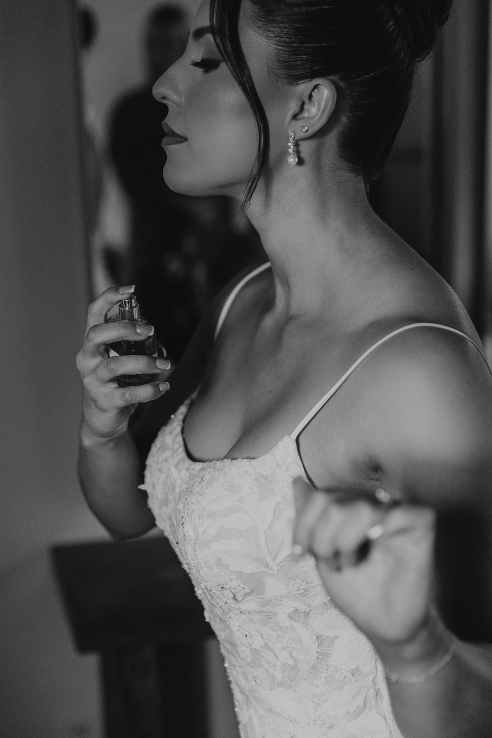 A black and white artistic series of profile shots showing a bride in a lace wedding dress.