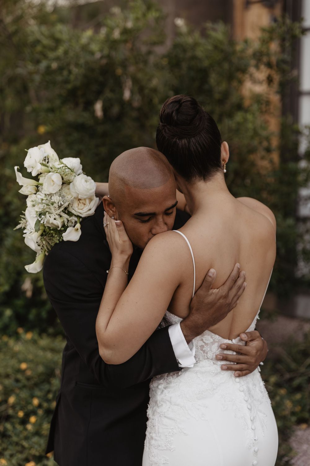 A tender moment captured in a series of wedding photos showing a couple embracing outdoors among greenery.