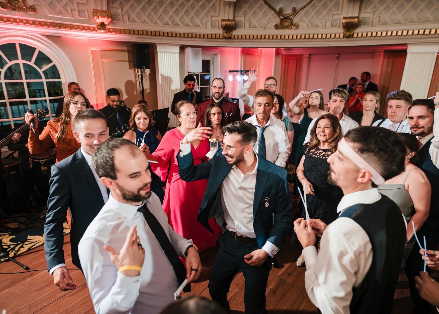 Groom dancing in the center of a circle of guests during a high-energy wedding reception dance floor at the Lenox Hotel Boston