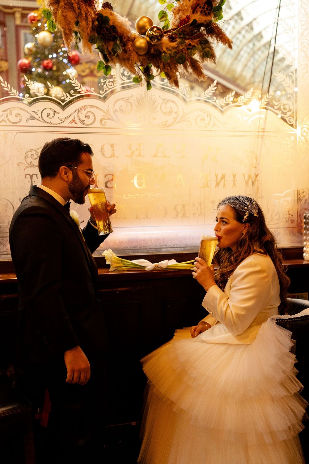 A wedding celebration moment captured in an ornately decorated dining room with autumn-themed decor.