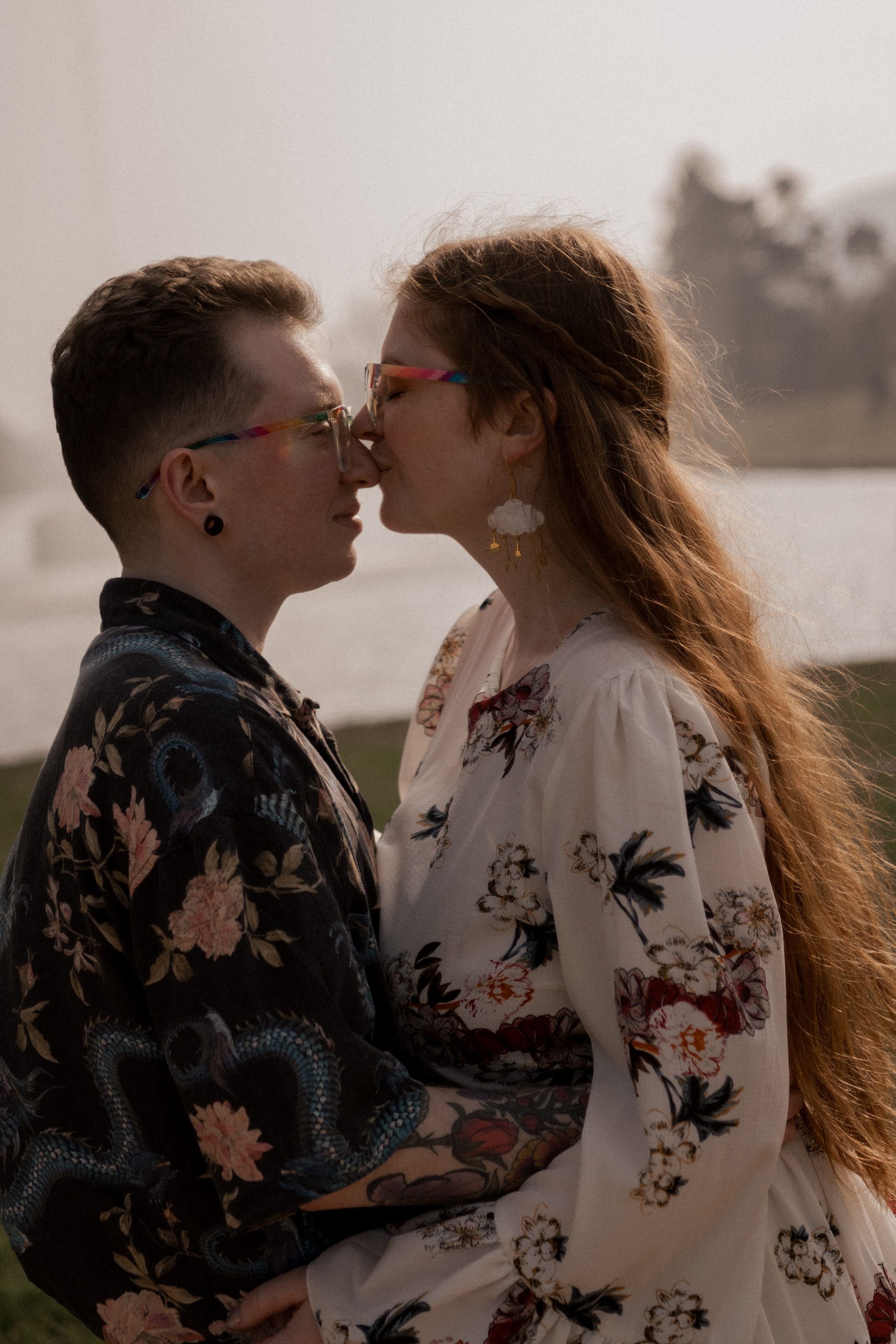 An intimate moment shared between a couple wearing matching floral patterns at sunset.