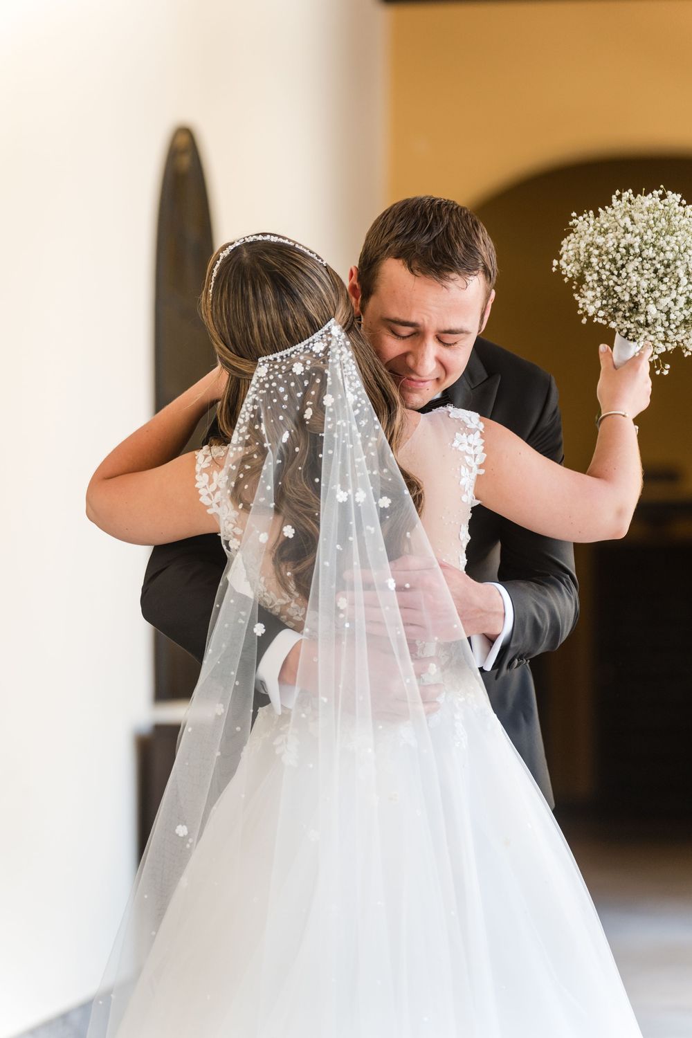 Bride and groom sharing emotional first look in courtyard at Hotel El Convento