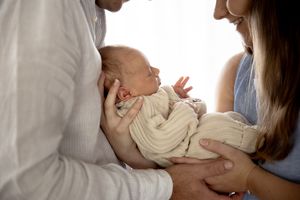 Family photo in lounge room at new born professional photo shoot