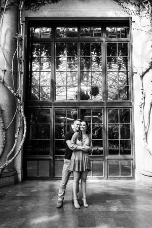 A series of black and white photos showing a couple dancing together outside a building with large windows.