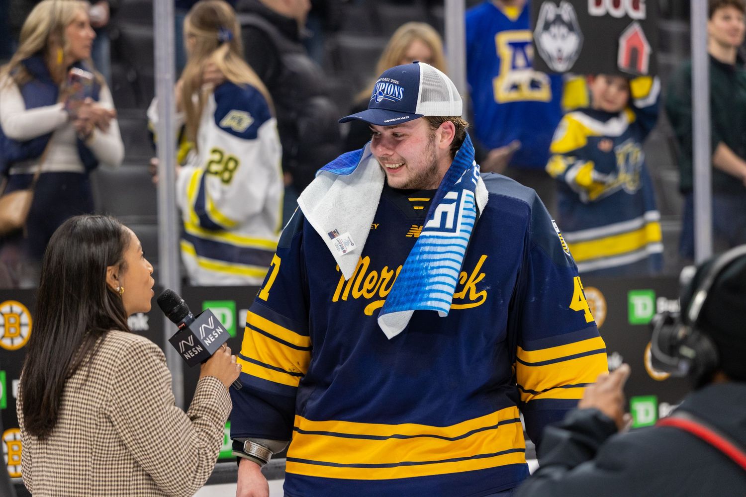 Hockey players and supporters celebrate together at arena event.