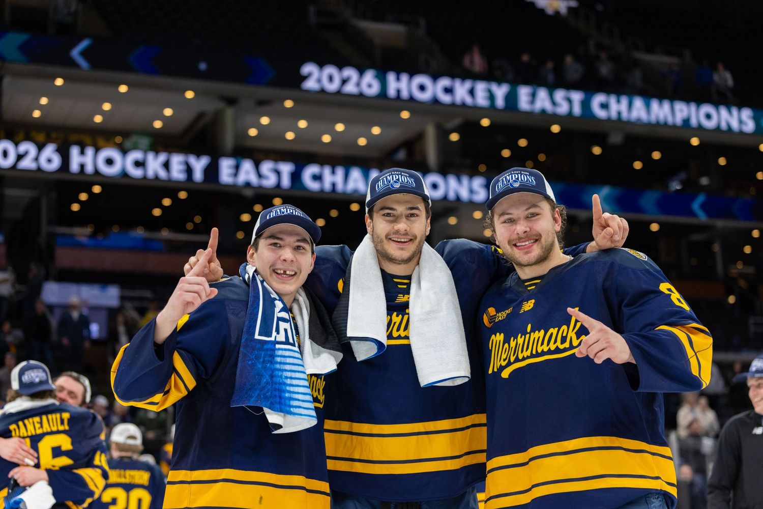 Hockey team members gather for championship celebration photo on ice.