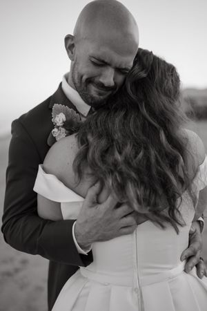 Black and white wedding photo series showing intimate romantic moments between newlyweds embracing and smiling.
