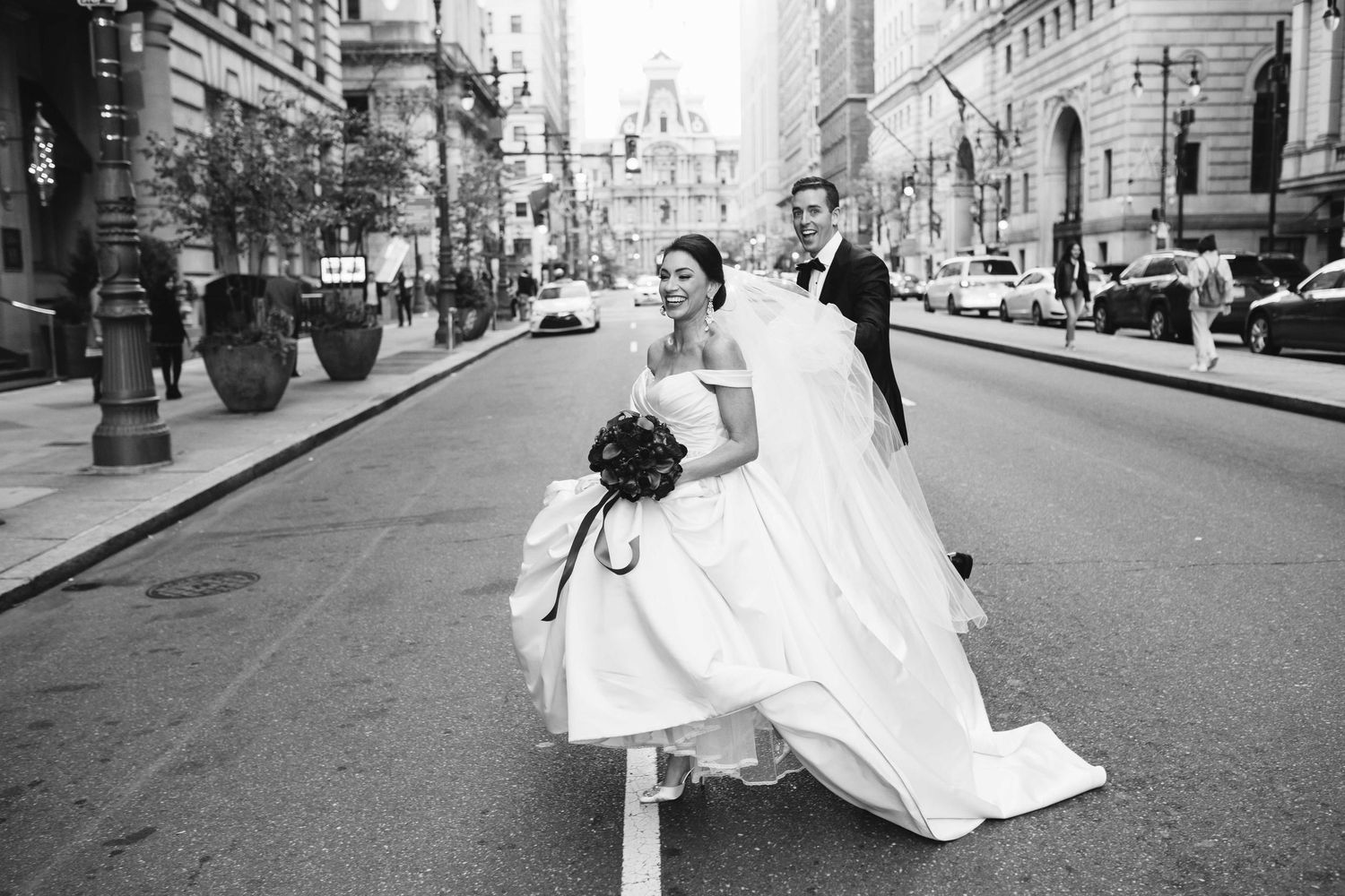 A black and white photo series showing a wedding couple posing on city streets with elegant architecture in the background.