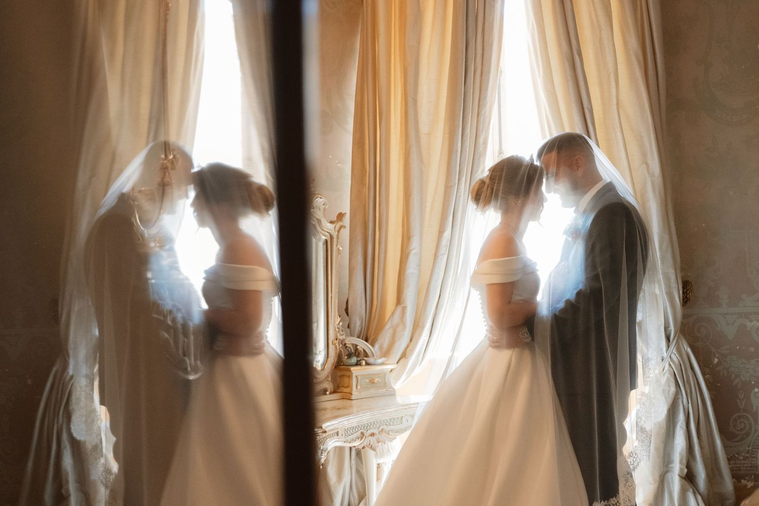 Close-up shot of hands exchanging wedding rings during an outdoor ceremony.