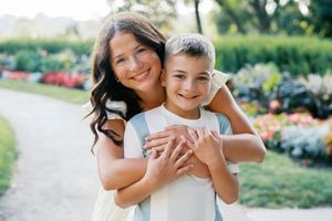 A collection of candid outdoor family photos showing joyful embraces and smiles in a garden setting.
