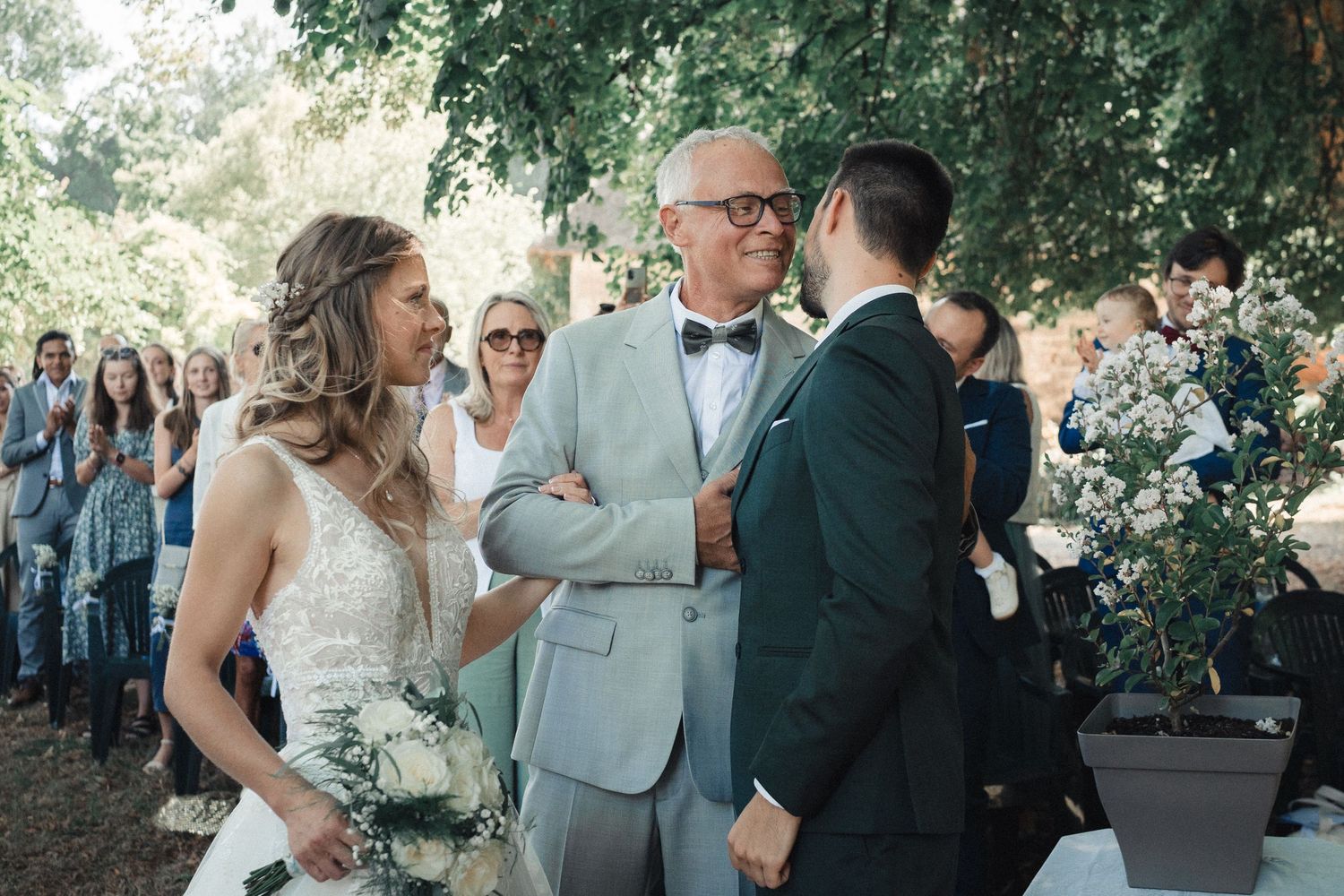 A series of candid outdoor wedding moments captured under green trees on a sunny day.