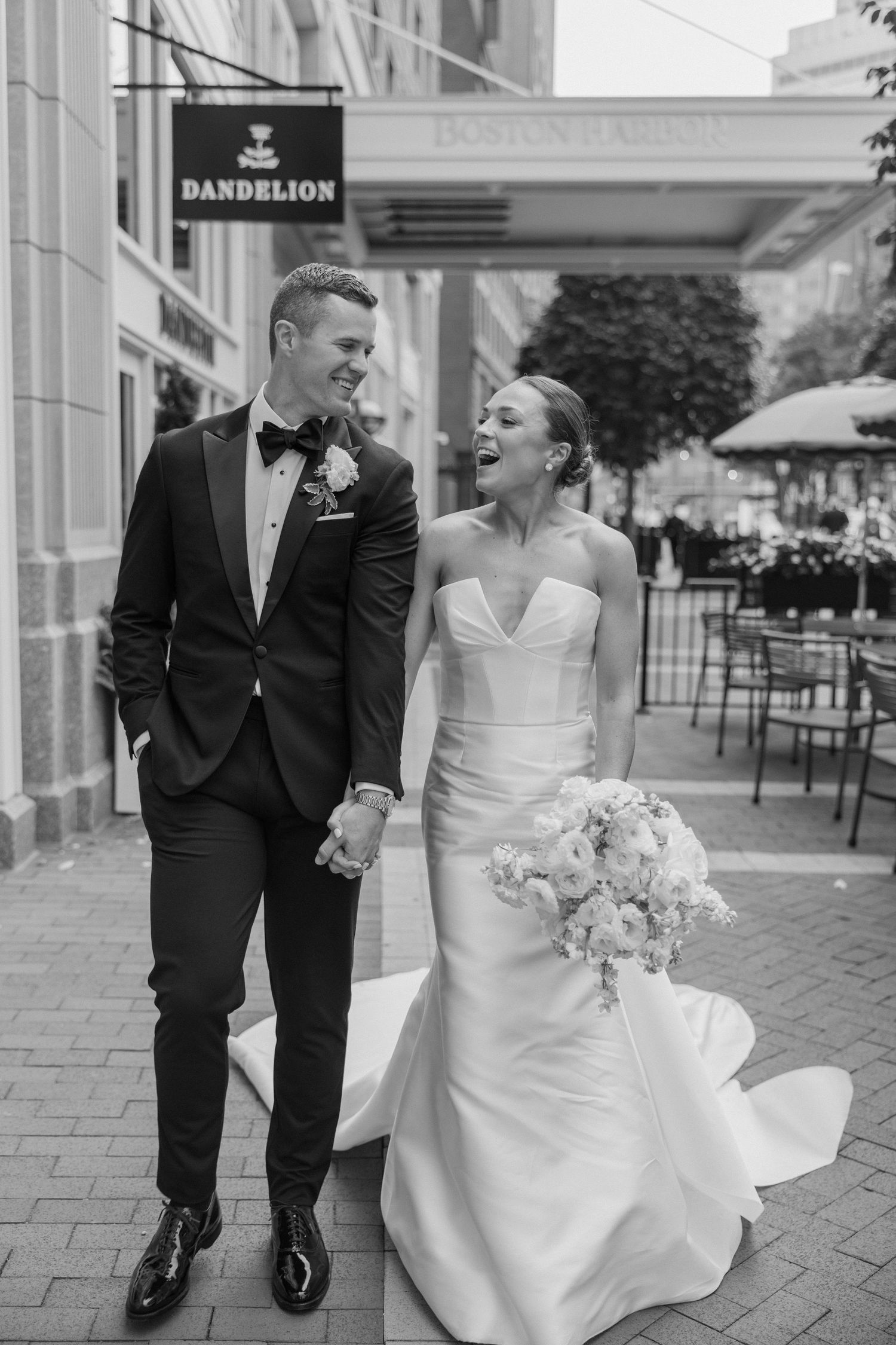 A stunning black and white wedding photo series showing a couple in formal attire on elegant marble steps.