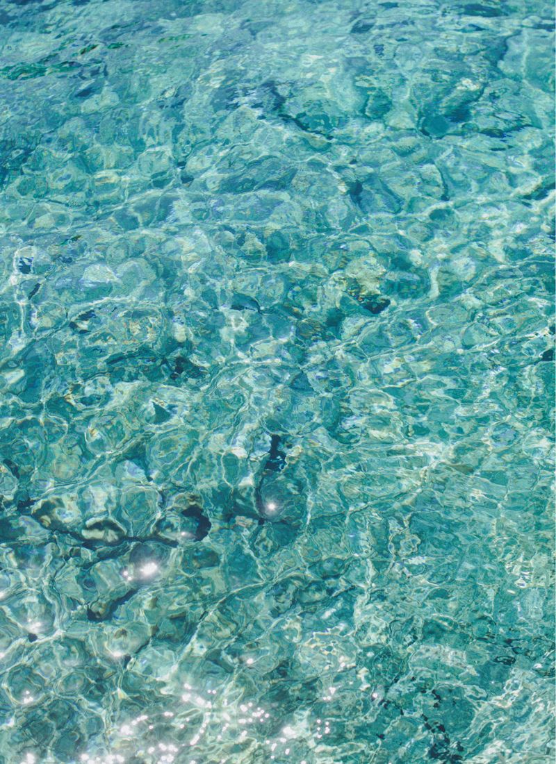 Crystal clear water texture in Santorini reflecting natural light