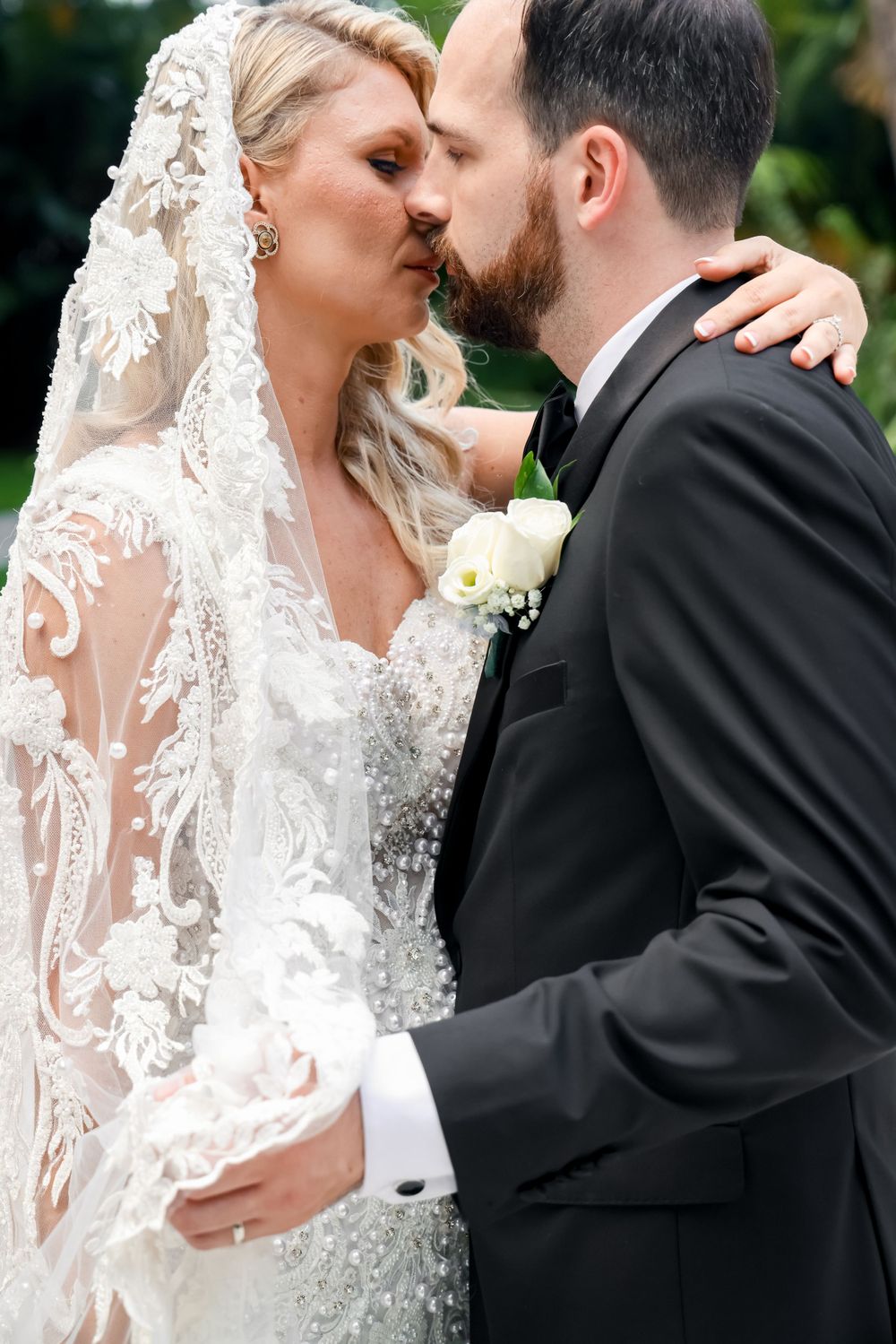 Intimate wedding portrait showing lace details and romantic moment.