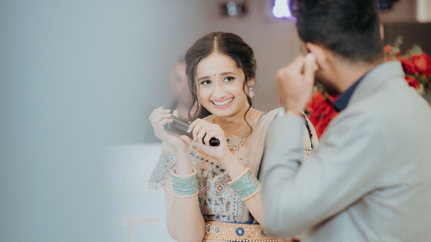 A candid moment captured during a wedding celebration with sparkly decor.