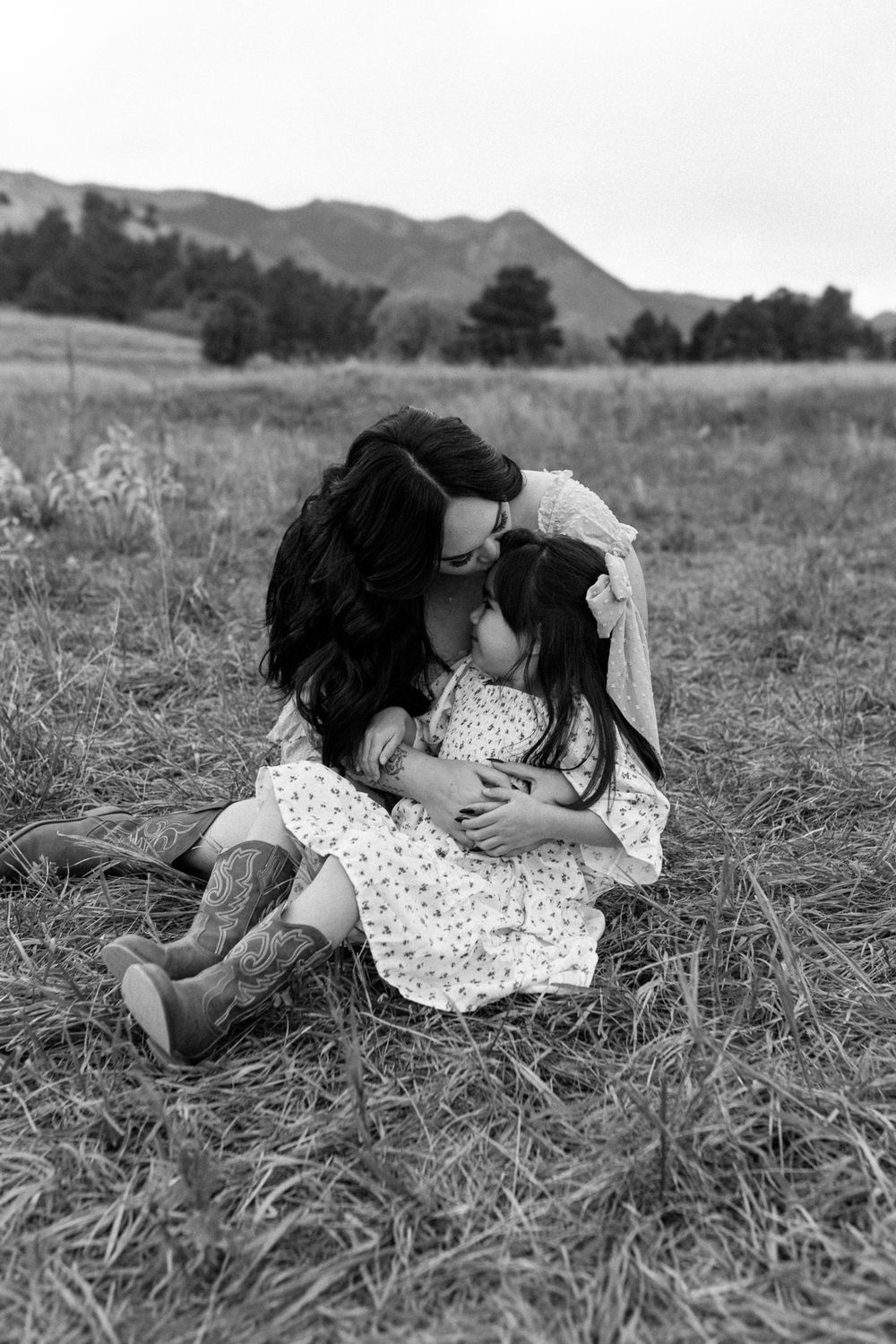 Black and white portrait capturing intimate moment in mountain field. Colorado Springs Photographer.