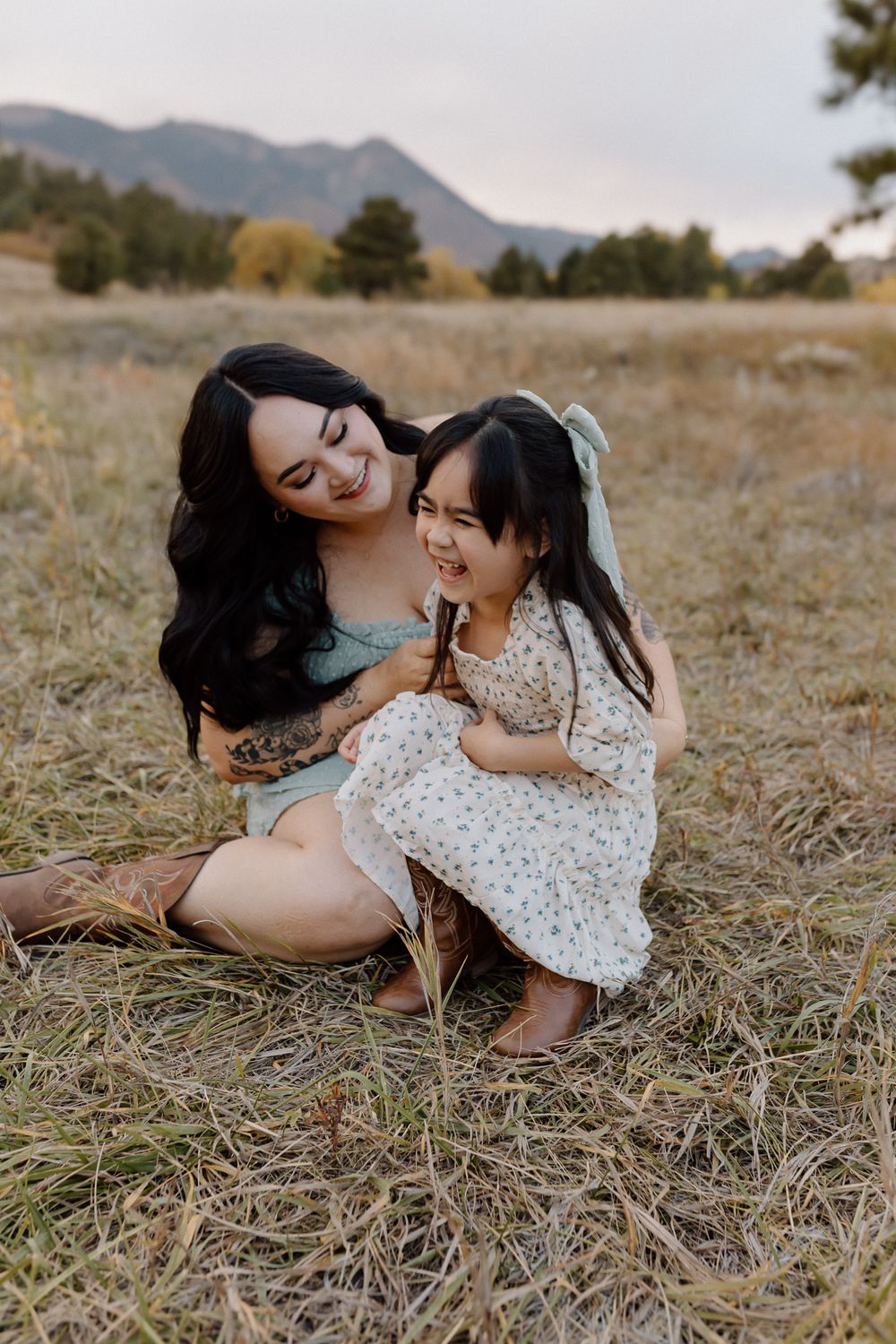 Candid moment of shared joy captured during outdoor mountain portrait session. Colorado Springs Photographer.