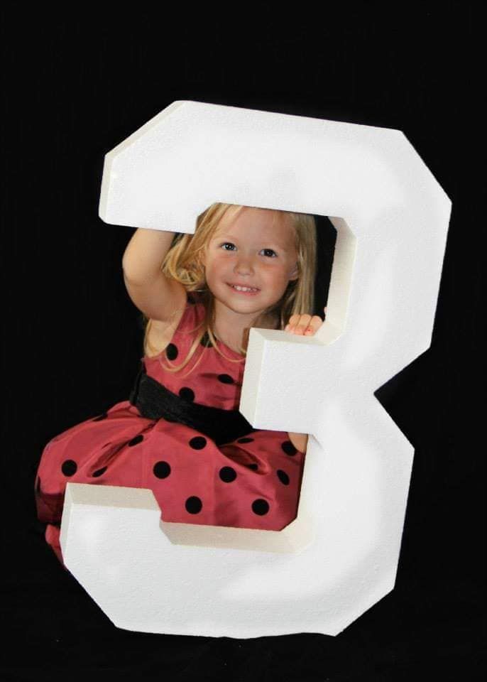 Creative number 3 prop used in children's photography setup.