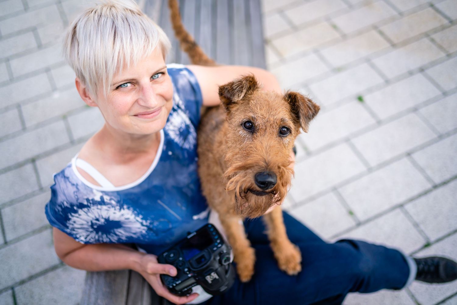 Diane from Dogs In Focus Photography and her Irish Terrier Deedee looking into the camera in Eastbourne