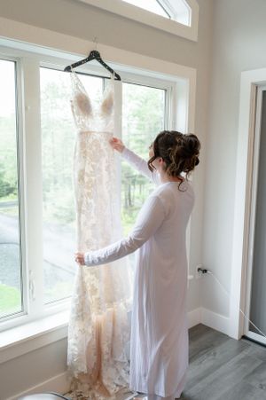 bride getting her dress ready to change into it