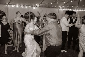 bride dancing with guests at her reception enjoying the night with family and friends