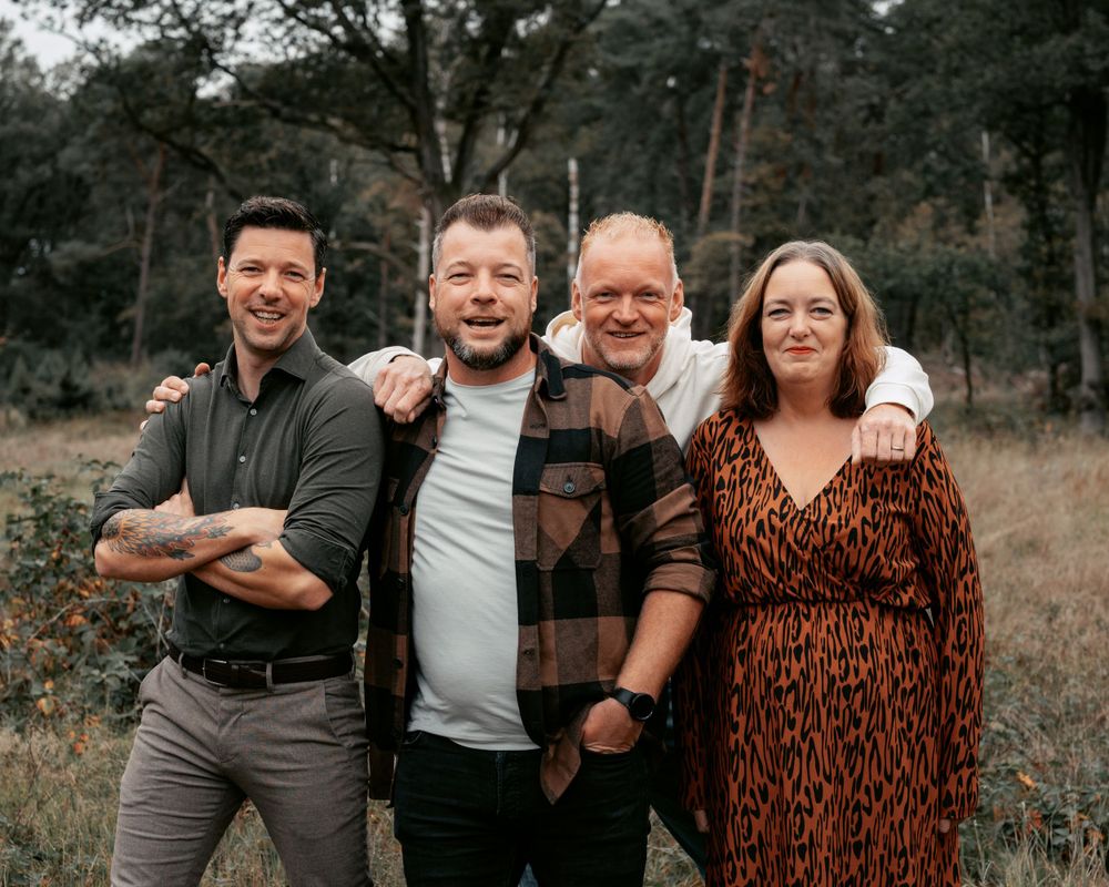 A group poses together for a casual outdoor family portrait.