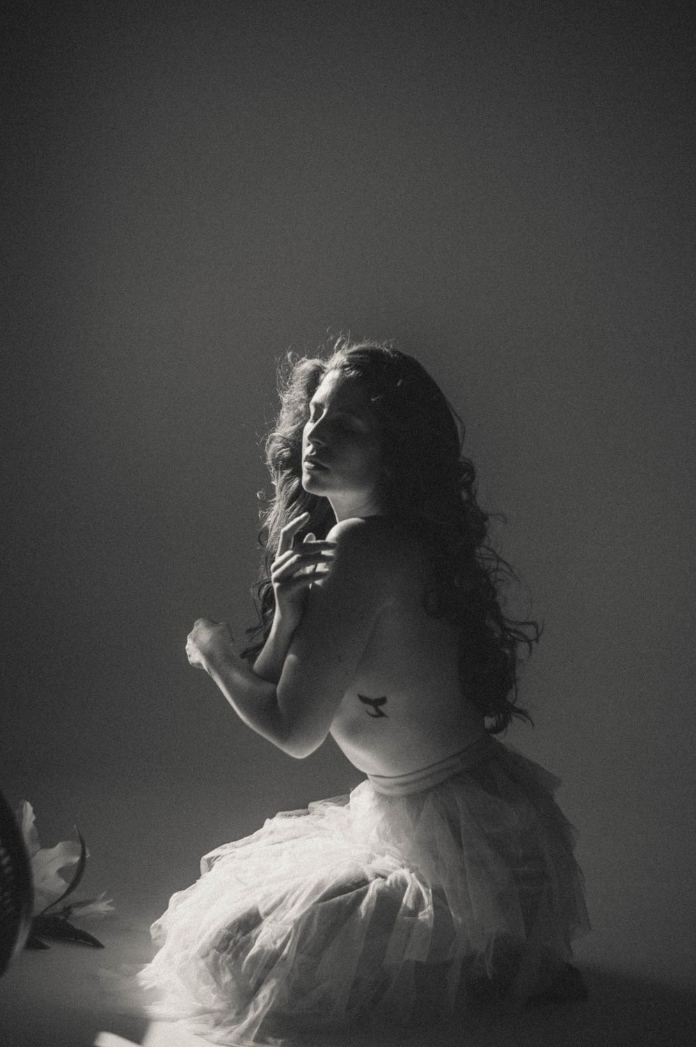 Artistic black and white portrait series showing dramatic lighting and ethereal poses.