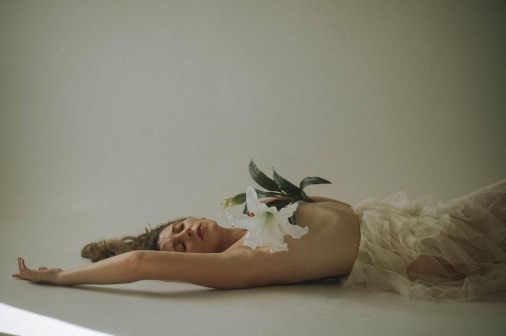 Minimalist portrait series with figure reclining against neutral background.