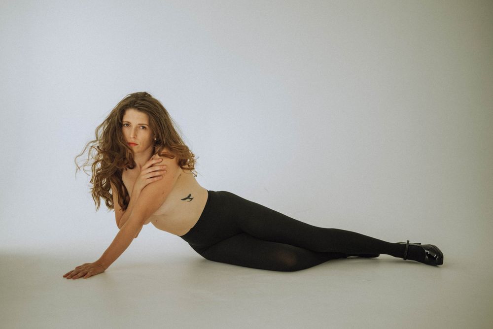 Artistic portrait series showing flowing movement against minimalist background.
