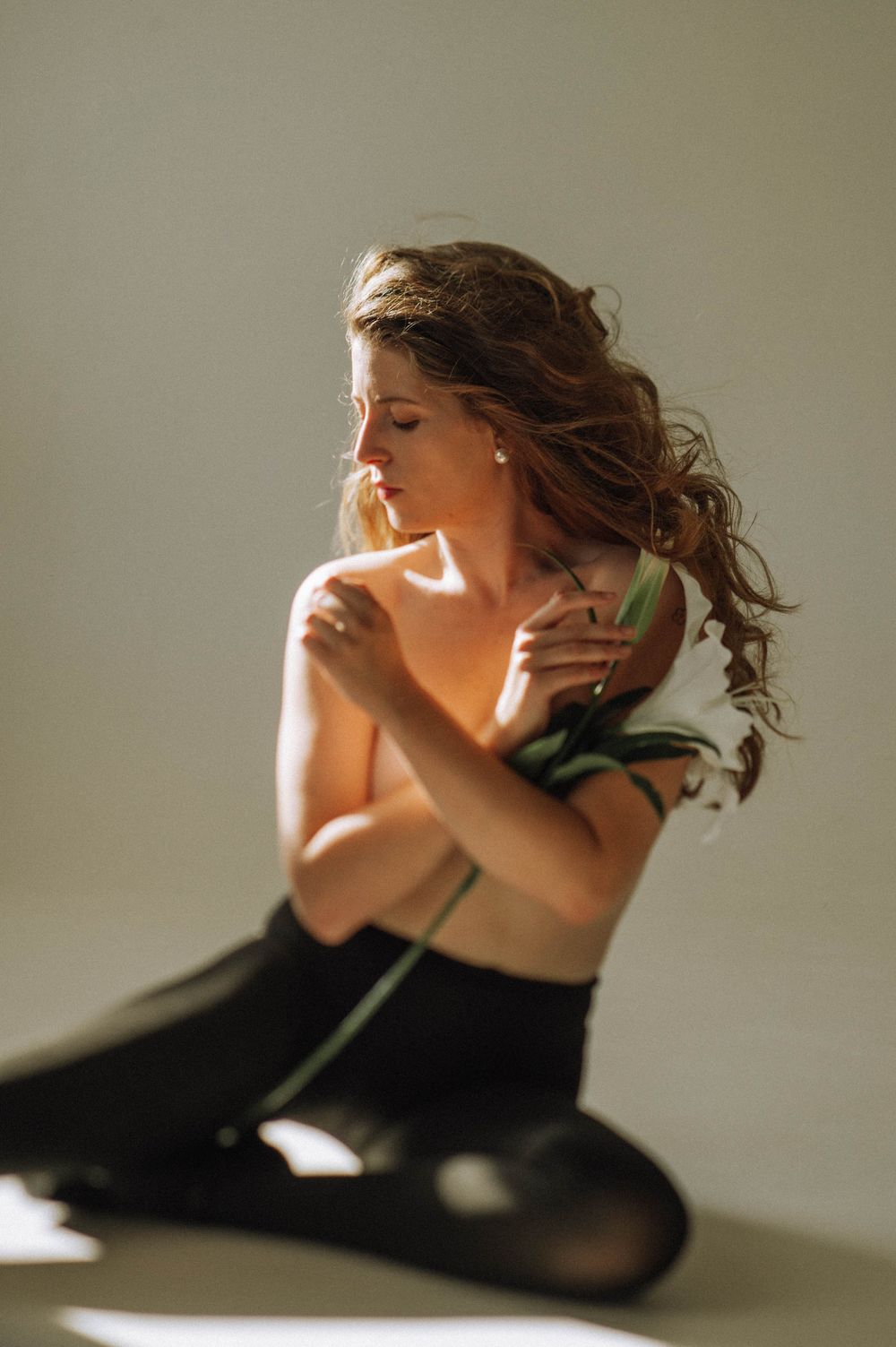 Artistic portrait series showing movement and emotion in moody lighting.