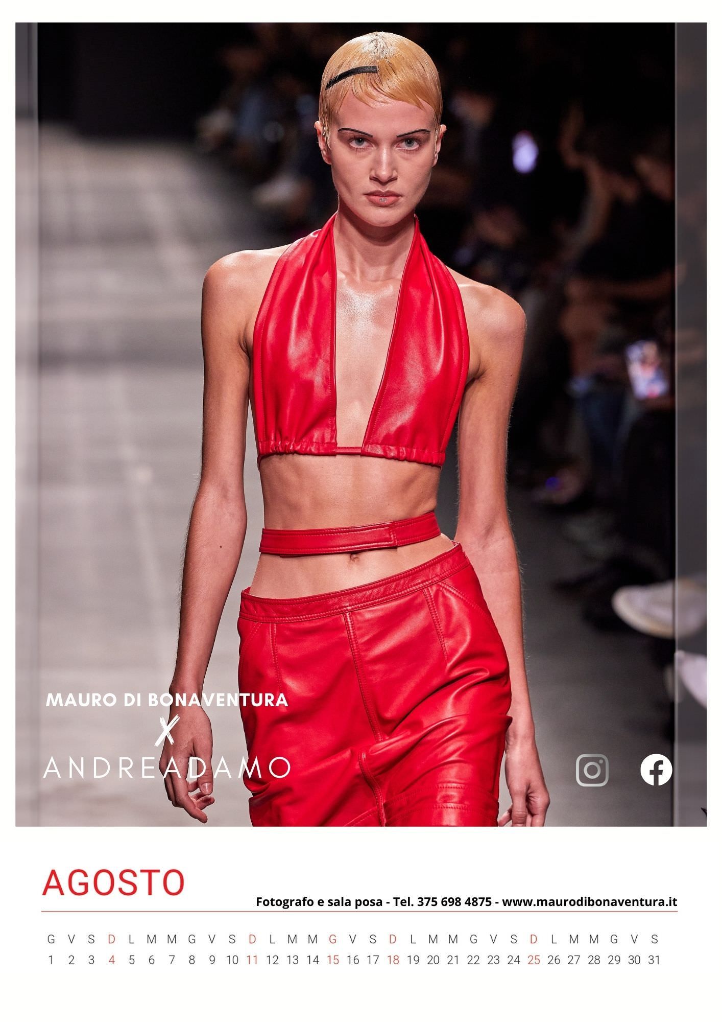 Fashion model wearing a bright red two-piece halter crop top and pants ensemble on the runway.