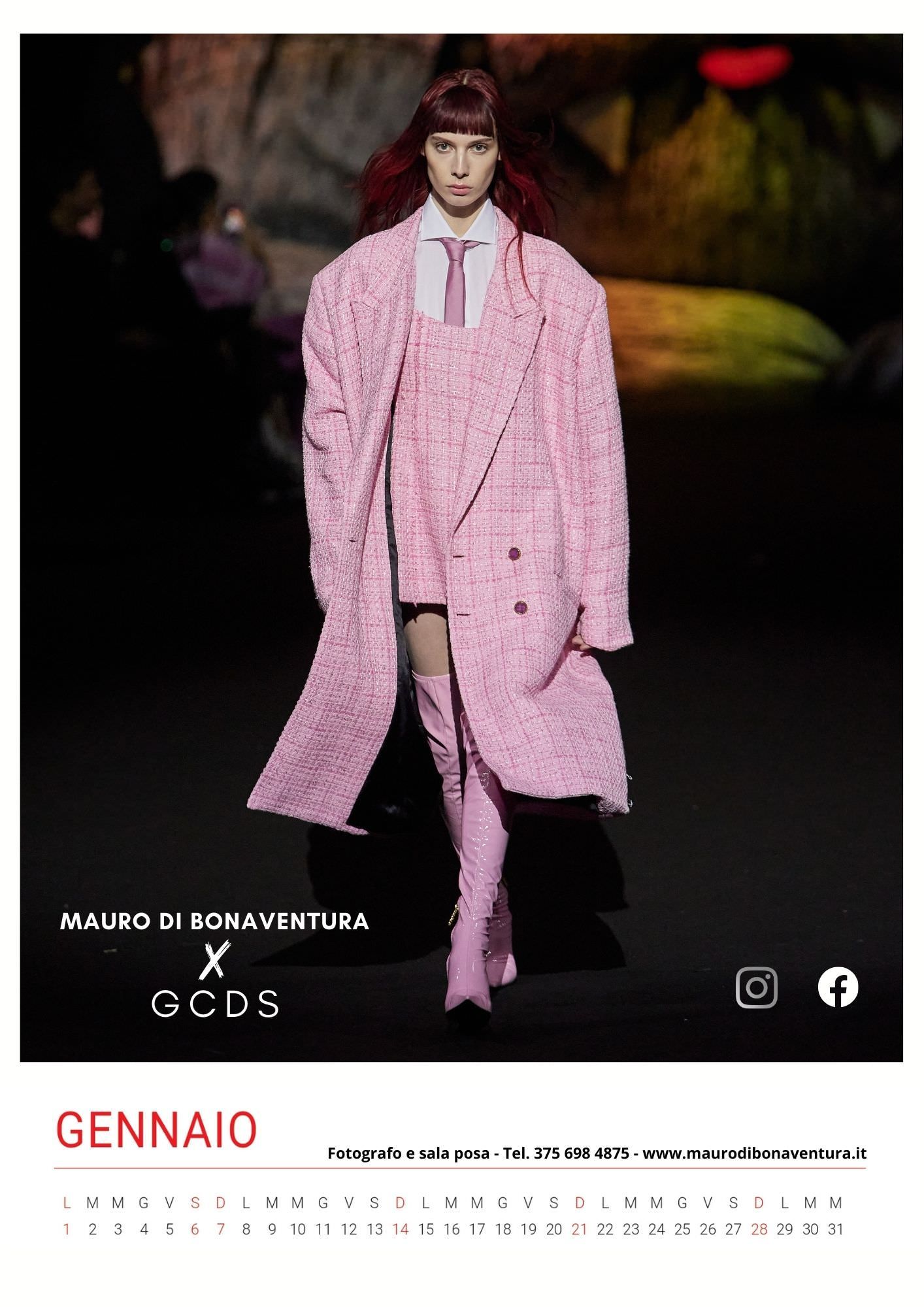 All-pink ensemble featuring oversized plaid coat and boots on dark runway.
