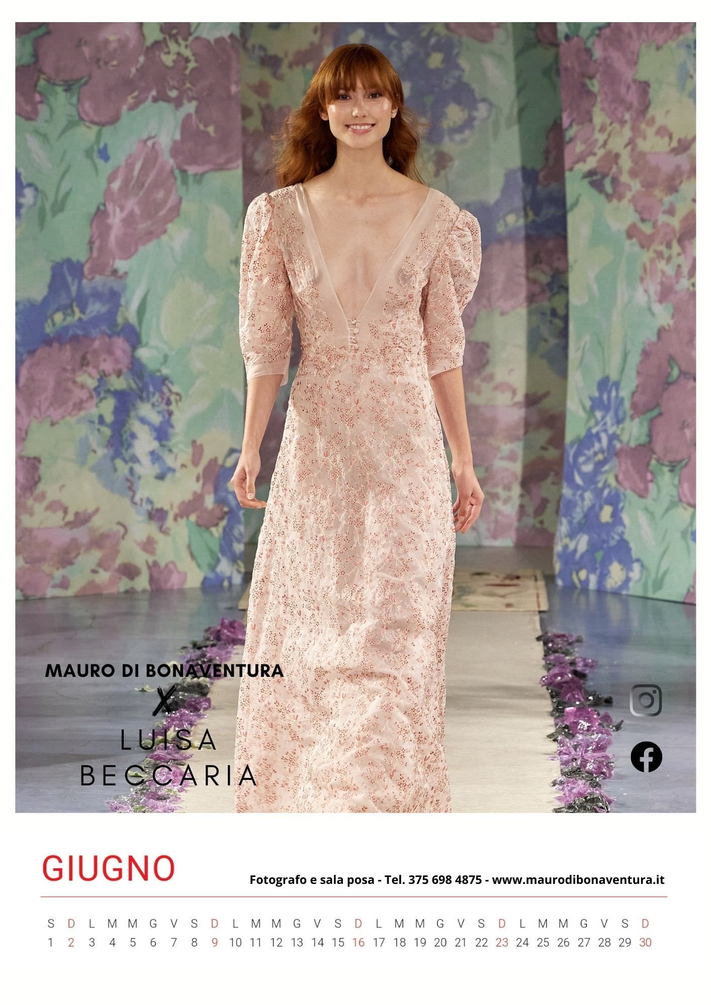Pale pink sequined gown with puff sleeves on runway against floral backdrop.