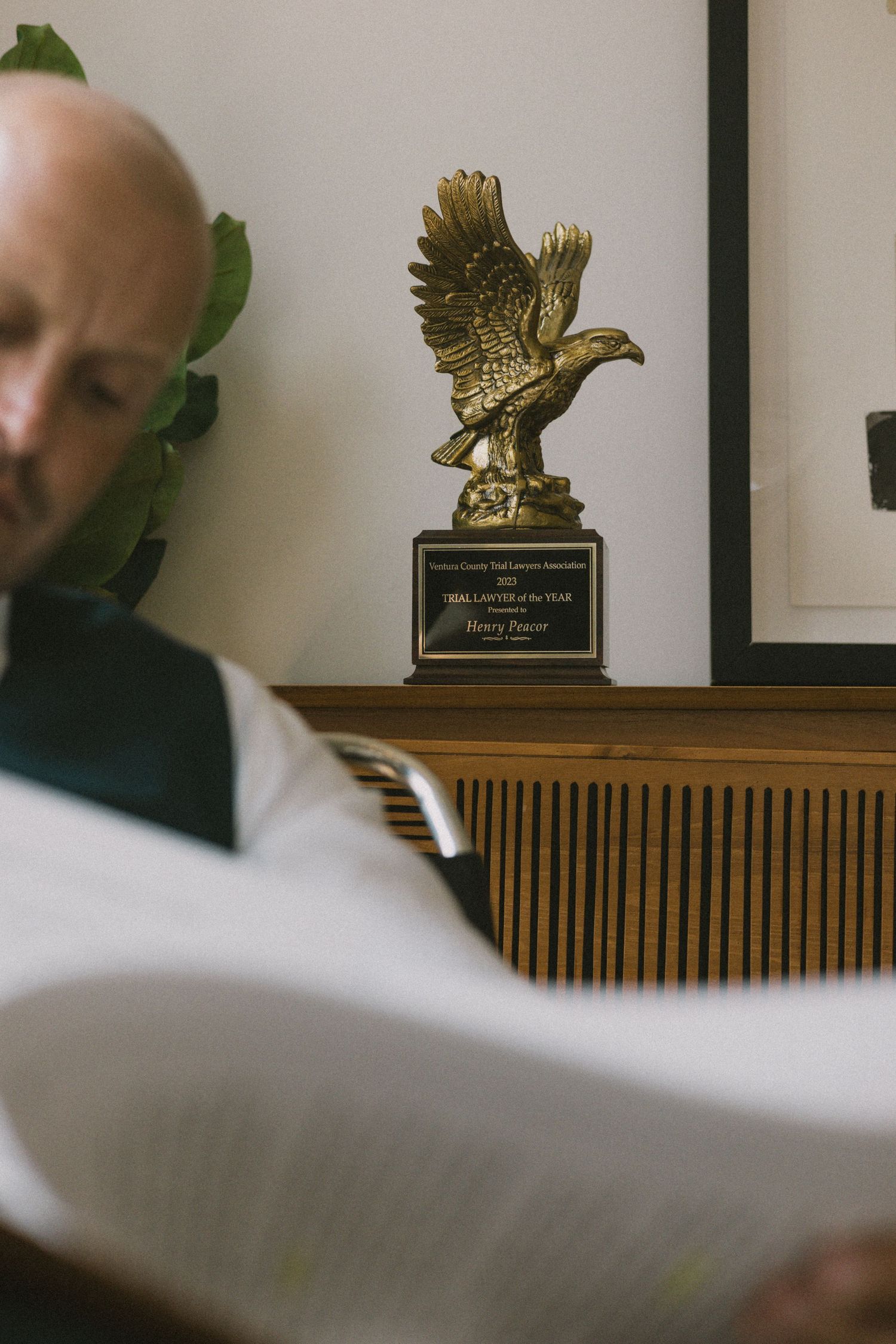 Golden eagle trophy or award displayed on a wooden mantel.
