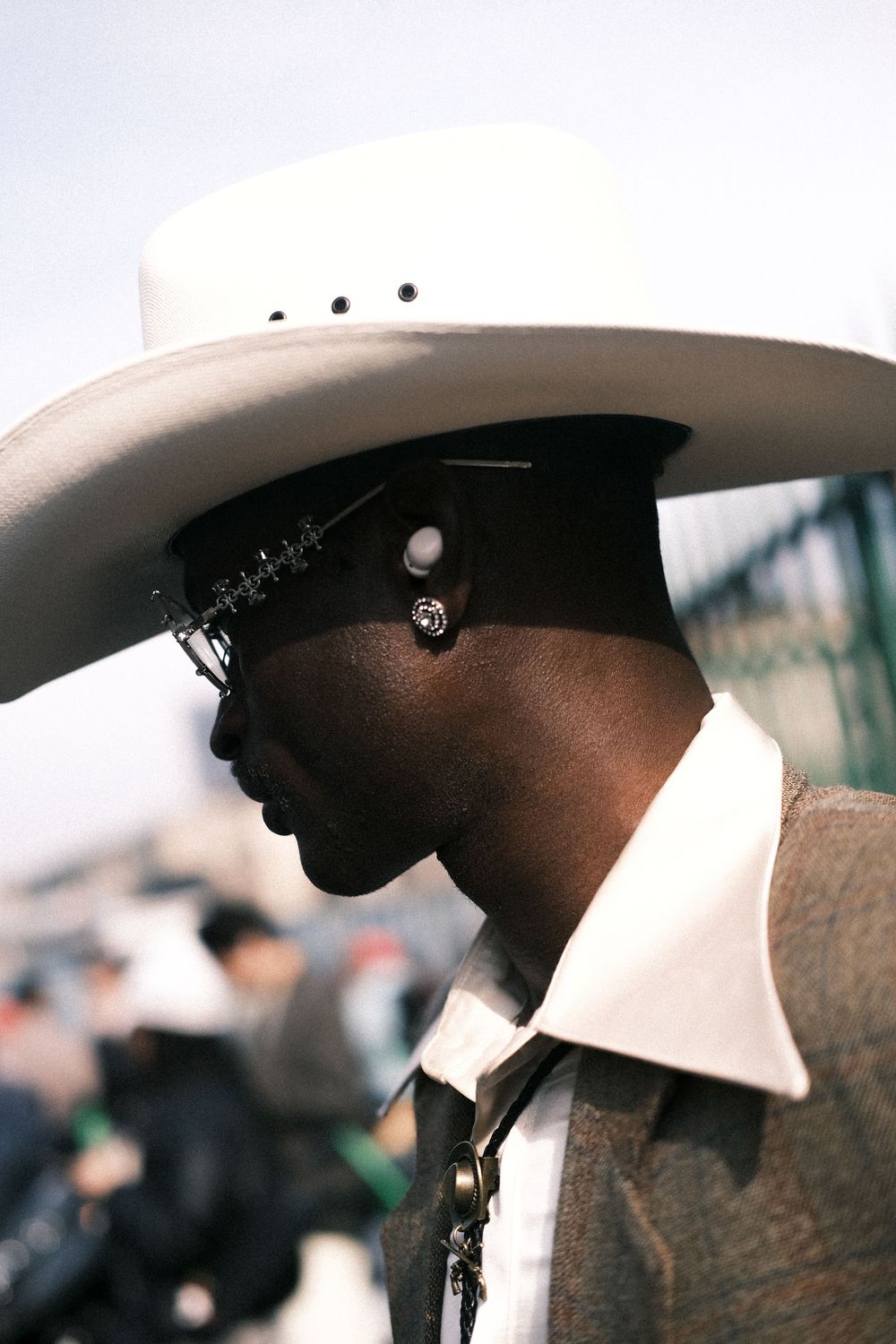 Stylish portrait of man in hat, modern candid fashion photography for expats and travelers in Milan fashion week.