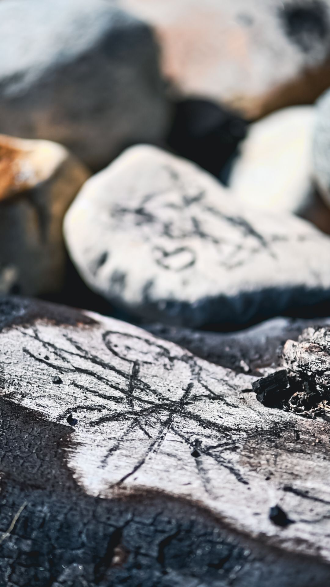 Ancient petroglyphs or rock carvings with symbols and markings etched into stone surface.