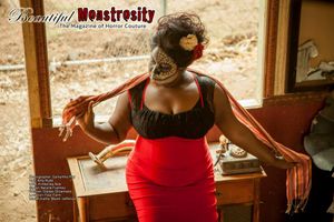 Figure in red dress and black top poses dramatically by vintage furniture.