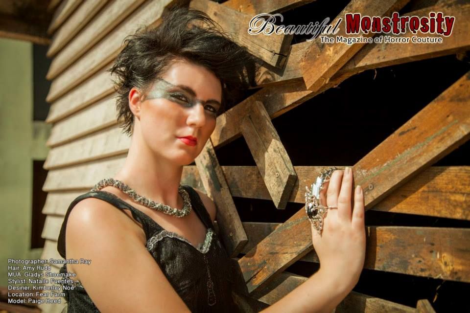 Retro-styled photo of model in dark dress against wooden architectural detail.