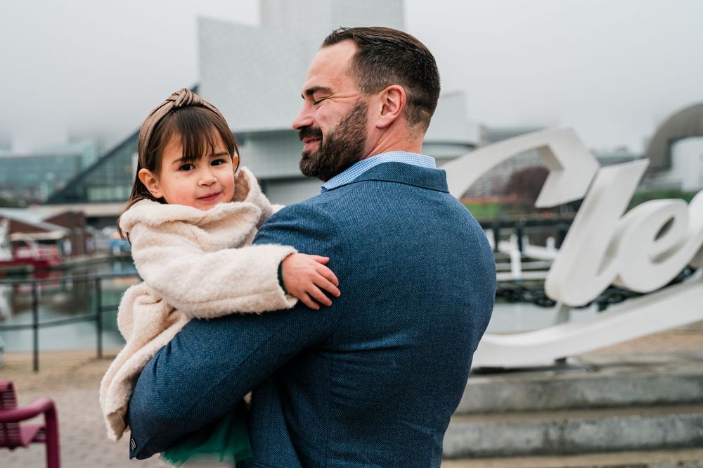 Heartwarming moment between parent and child against modern architectural backdrop.