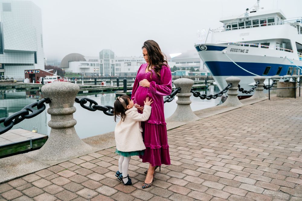 A waterfront portrait with boats and harbor views in the background.